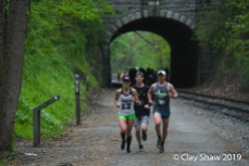 Megan DiGregorio of Baltimore running top master Pete LoBianco #204 just south of the Howard Tunnel, in the pouring rain.
