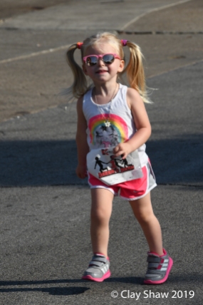 Cute kid in the fun run with her shades.